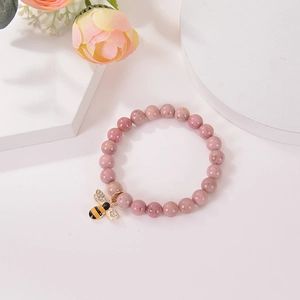 Detail of pink natural agate bracelet with a micro-pave zircon honeybee charm pendant