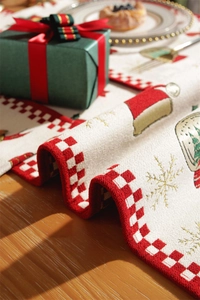 Detailed close-up of Christmas table runner with embroidered snowflakes and festive hats