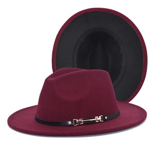 Detail of burgundy wool fedora featuring black leather band and gold metal buckle accent