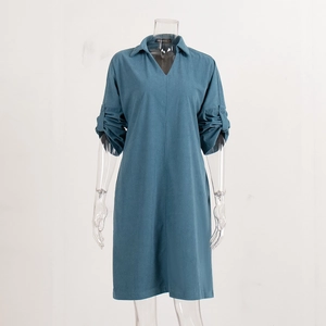 Detail of V-neck collar and button sleeve tab on a dusty blue corduroy midi dress