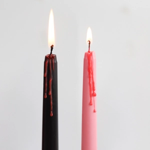 Halloween bleeding long taper candles in black and pink with red wax drip detail
