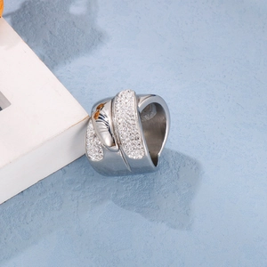 Detailed view of silver stainless steel crisscross ring with pavé cubic zirconia
