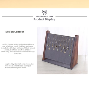 Detail view of walnut wood jewelry organizer with 12 hooks and dark grey velvet backing
