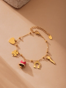 Detail of 18K gold plated stainless steel bracelet with heart and clover charms