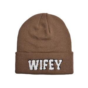 Close-up of the dark brown knitted beanie featuring white plush WIFEY letter embroidery