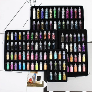 Macro shot of assorted colorful nail art glitter powder and sequins in small glass bottles
