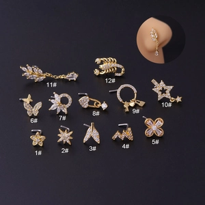 Detail view of 12 styles 20G titanium steel nose studs featuring cubic zirconia designs