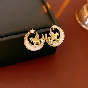 Vintage gold Pegasus and crescent moon stud earrings with zircon stone on jewelry box