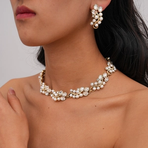 Macro shot of baroque pearl and crystal choker necklace with matching floral earrings