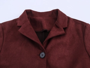 Close-up of the lapel collar and button detail on a burgundy faux suede jacket