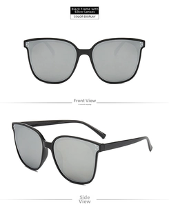 Detail of oversized black frame sunglasses with silver mirrored lenses and triple dot studs