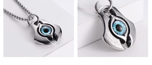 Macro detail of punk style stainless steel evil eye pendant with blue resin eyeball