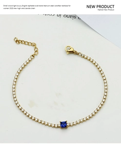 Close-up of titanium steel gold bracelet with blue square zircon and white micro diamonds