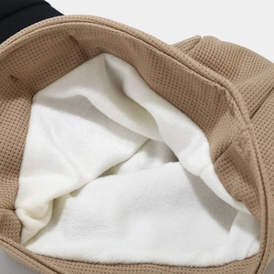 Close-up of khaki waffle knit beanie featuring thick white fleece lining for warmth