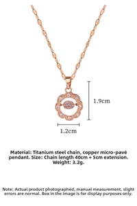Macro detail of rose gold titanium necklace with pink crystal and flower pendant