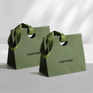 Close-up of olive green trapezoid gift bag with litchi texture and silk ribbon handle