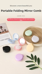 Detail of colorful round folding travel hairbrush with mirror in macaron colors