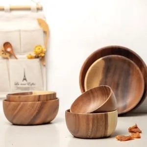 Close-up of premium acacia wood dinnerware set with natural grain and smooth rounded edges
