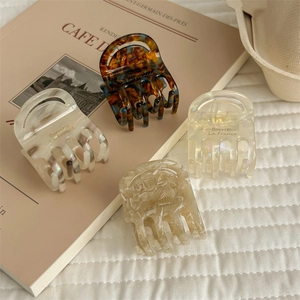 Set of four premium acetate hair claws in amber, marble, and pearl white French style