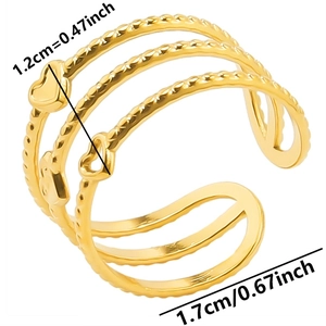 Detail showing the adjustable open design and heart charms on a golden steel ring
