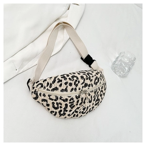 Close-up of leopard print straw fanny pack with adjustable strap and buckle closure