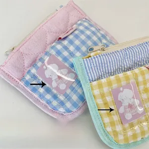 Detail of fabric coin purses with quilted pink, blue and yellow checkered patterns