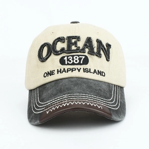 Detail of OCEAN 3D embroidery on vintage contrast color baseball cap with distressed brim