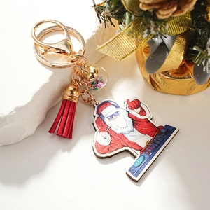 Festive Christmas keychain with Santa pendant, red tassel, and star-filled glass ball