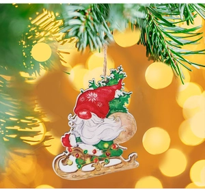 Close-up of wooden Christmas gnome ornament hanging on tree branch with bokeh light