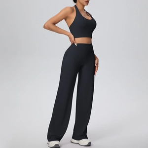 Detail view of black halter yoga set featuring backless sports bra and wide-leg yoga pants