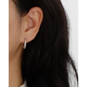 Close-up of model wearing silver s925 C-shaped hoop earrings with sparkling micro diamonds