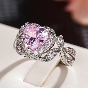 Romantic silver ring featuring a large pink heart gemstone with sparkling crystal accents