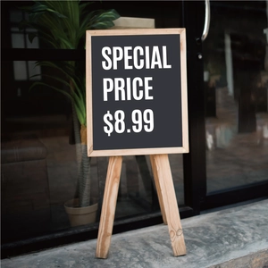Close-up of foldable wooden easel display with a chalkboard for cafe menus and signage