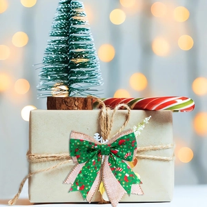 Double-layered Christmas bow with festive patterns on kraft gift box decoration
