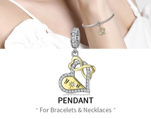 Detailed view of two-tone heart pendant with cubic zirconia and you engraving on bracelet