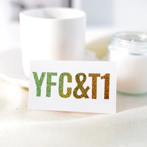 Detailed view of 1-inch holographic glitter letter stickers on textured white fabric