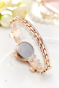 Detail view of the rose gold mesh strap and stainless steel back of the women's fashion watch