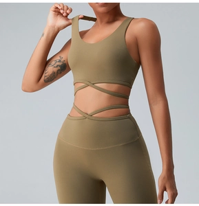 Detail of olive green sports bra with multi-strap crisscross waist and high-waist yoga pants