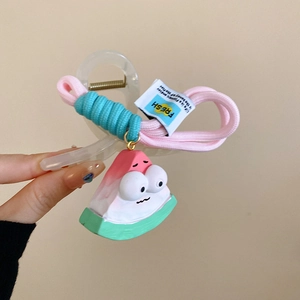 Detailed view of a handmade cartoon watermelon hair claw clip with pink woven rope