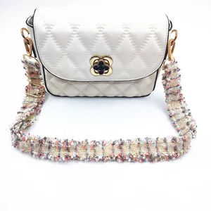 White quilted shoulder bag with pink tweed woven strap and gold floral metal buckle
