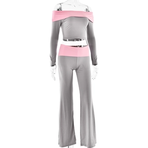 Detail of grey and pink contrast long sleeve off-shoulder crop top and flared pants