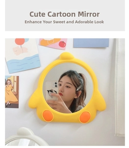 Close-up of yellow cartoon chicken makeup mirror hanging on a white wall decor