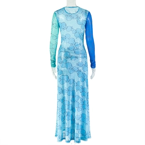 Back view of a mesh long-sleeve dress with blue and green color blocking on a mannequin