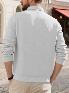 Detail of light grey vintage textured knit fabric on men's long sleeve polo sweatshirt