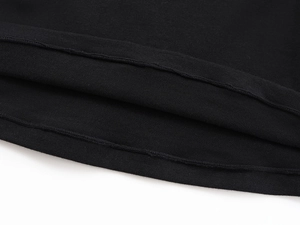 Close-up of double-needle hem stitching on black soft knit slim fit t-shirt fabric