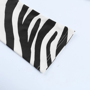 Close-up of zebra print knit fabric showing high-quality stitching and elastic texture