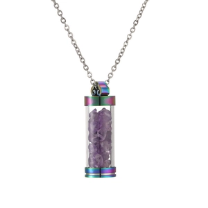 Detail of a rainbow metal perfume bottle pendant with purple crystal stones on a silver chain