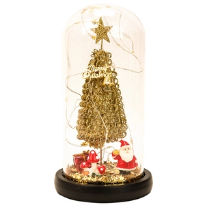 Detail of Christmas glass dome with golden tree, Santa, and festive LED string lights