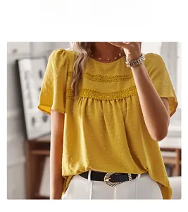Detail of yellow round neck blouse featuring polka dot texture and hollow lace crochet