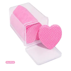 Macro shot of rose red heart-shaped eyelash glue wipes in a transparent storage box